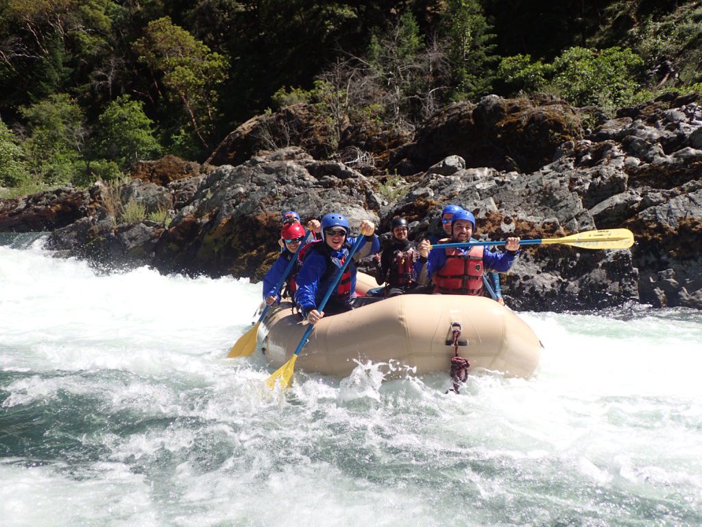 Guide School students in a tan colored raft successfully complete a rapid on the Trinity River..